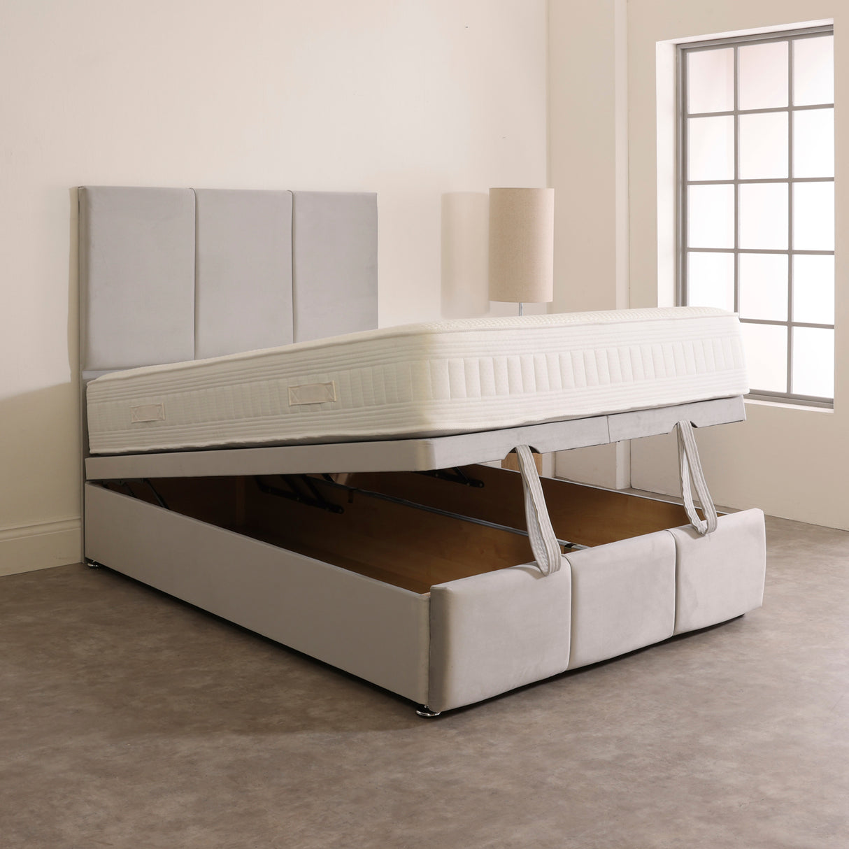 A Neptune Ottoman Storage Divan Bed Base with a beige fabric cover, featuring a headboard and FOOTBOARD OSG, with the ottoman storage space visible.